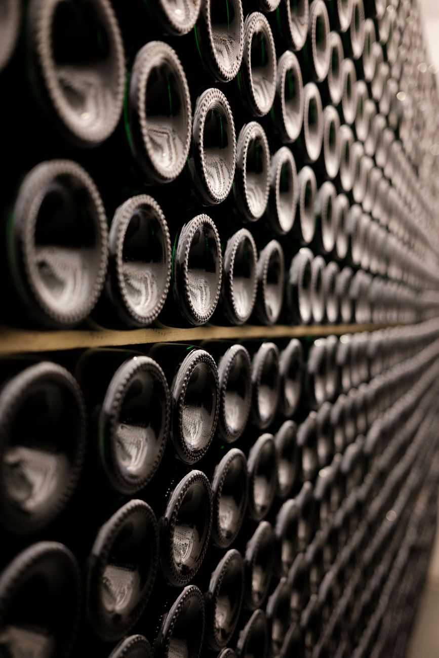Close-up of symmetrical rows of wine bottles in a Brussels wine cellar.